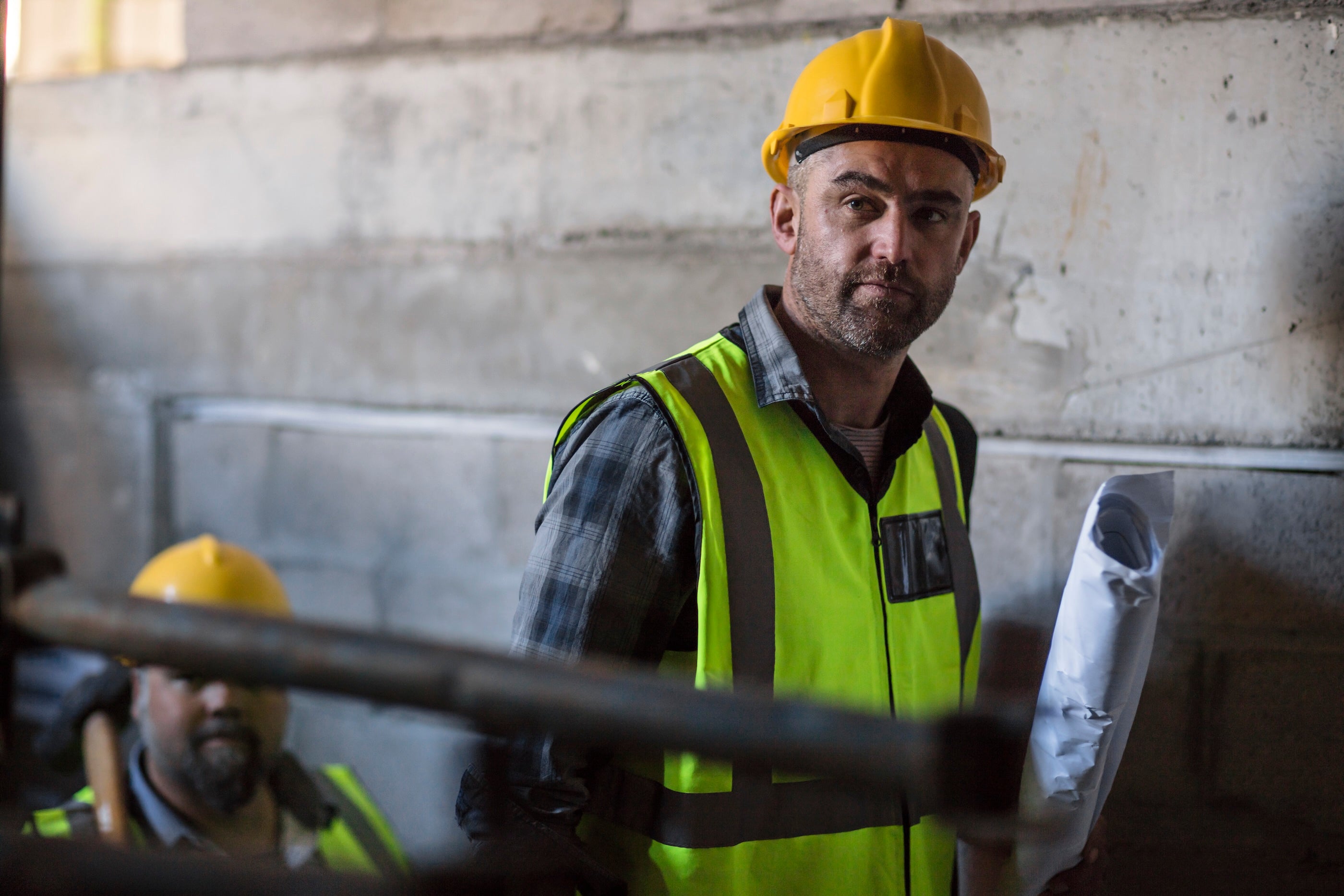 Worker wearing durable contractor gloves designed for impact and hand protection on the jobsite.