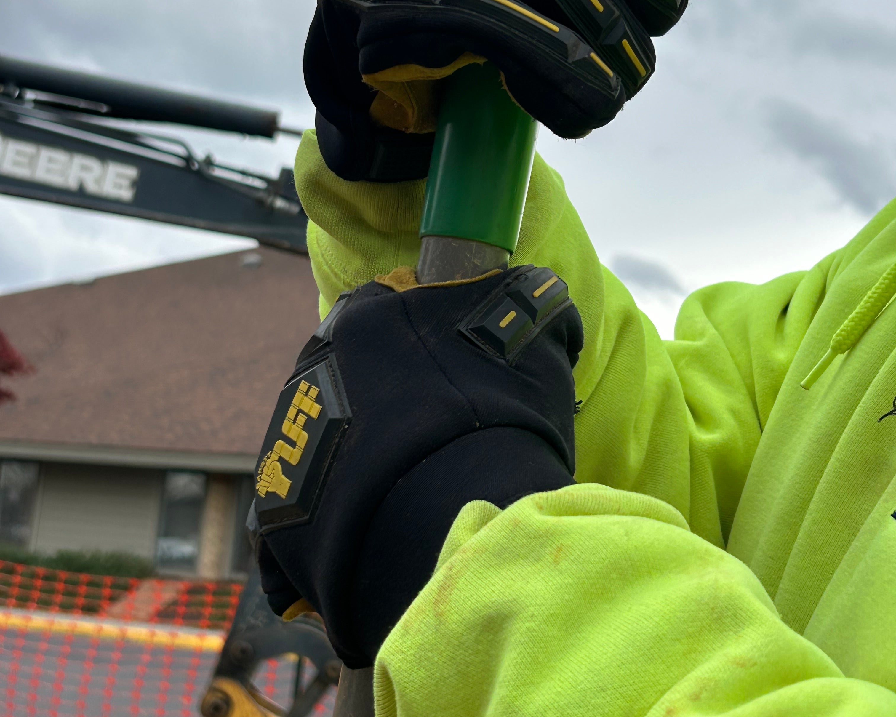 Another construction worker wearing Safety TUFF's 1000 impact glove while digging on a job site