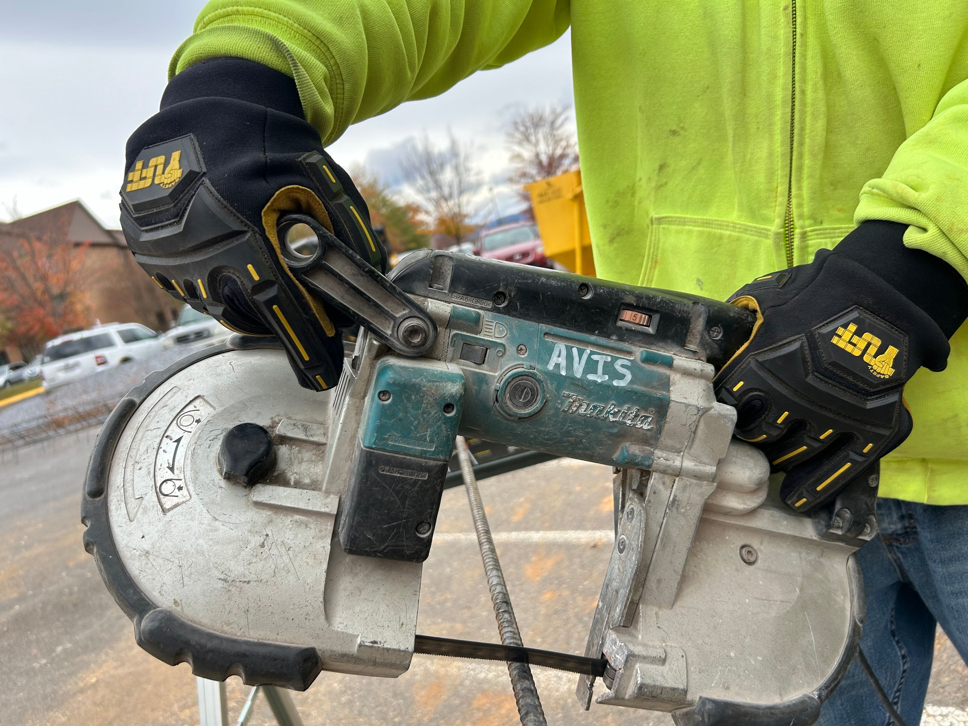 A contractor using a saw to saw rebar wearing Safety TUFF's 1050 Cut & Impact Resistant Safety Gloves