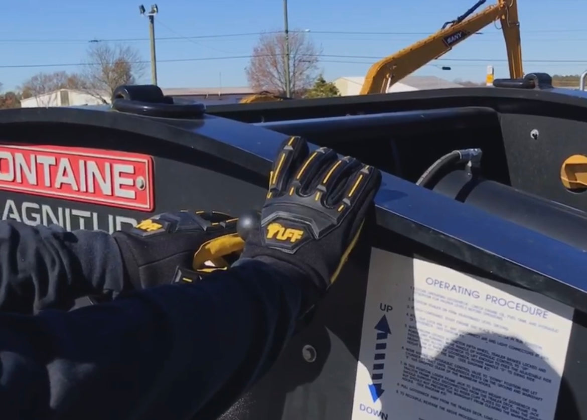 Someone who works with heavy machinery loading up a truck with Safety TUFF's 1000 impact gloves on